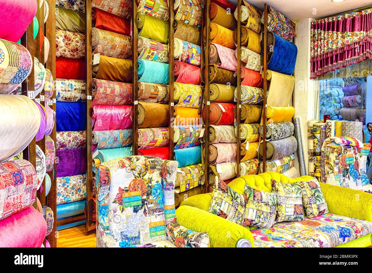 Rolls of Colorful upholstery material on sale in a shop on Al Muizz street in Khan El Khalili market Stock Photo