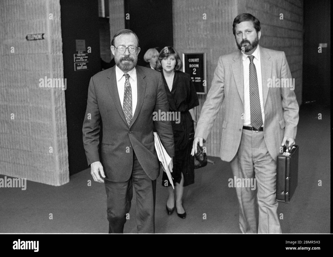 Wall Street securities analyst Joseph Pikul, left, with his lawyer, Ronald J. Bekoff at the Orange County Courthouse where is tried for the murder of his second wife, Diane Whitmore, at the Goshen, NY on January 15, 1989. Pikul’s third wife, Mary Bain, is shown in the background. Photo by Francis Specker Stock Photo