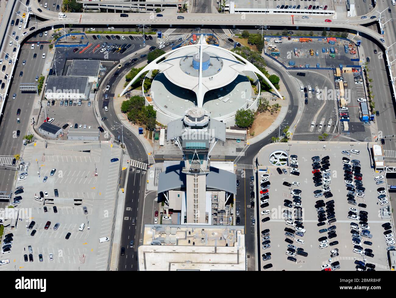 Air Traffic Control tower (ATC) and Theme Building at Los Angeles LAX Airport, USA. Multiple parking lots around Center Way and World Way Road. Stock Photo