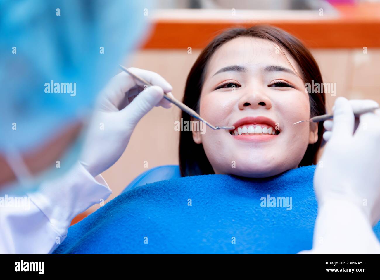 Dentistry and teeth healthcare concept at dental clinic. Dentist check-up teeth for young asian patient. Stock Photo