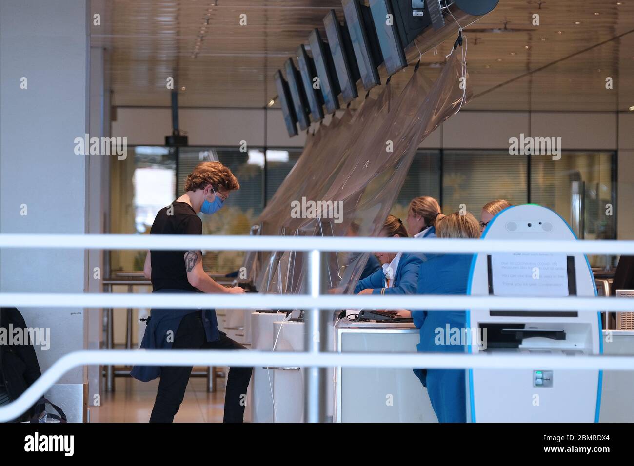 Travelers check in at KLM Royal Dutch Airlines desk at the departure