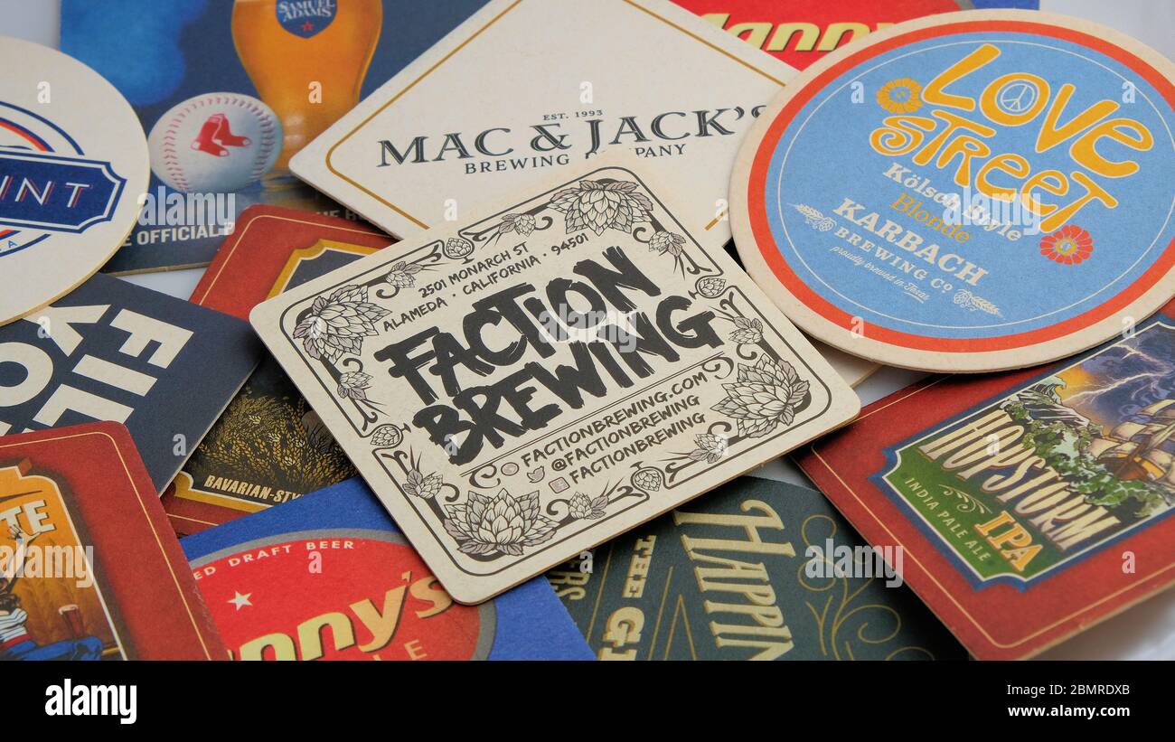 Assorted beer coasters or mats featuring American brews; Faction Brewing, Karbach, Mac & Jack's, Amstel. Stock Photo
