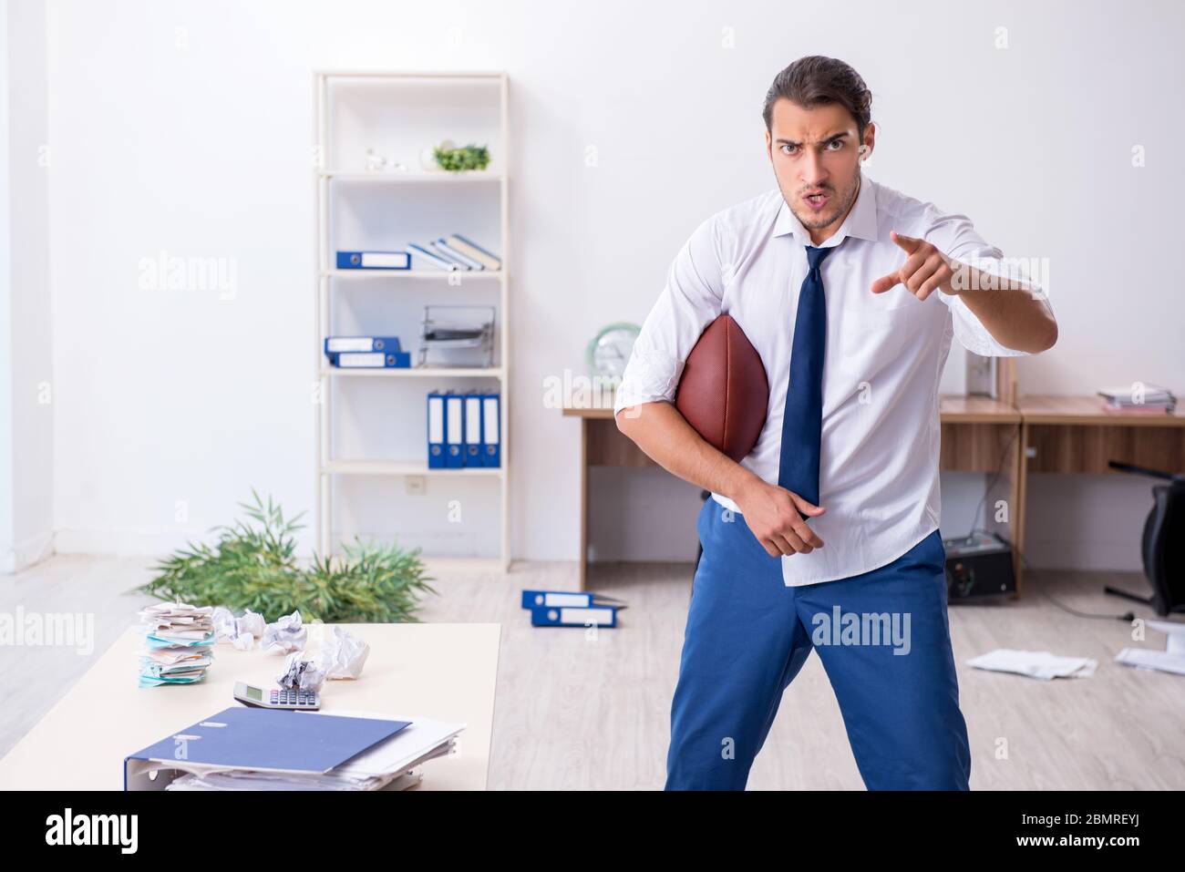 Young employee throwing rugby ball in the office Stock Photo Alamy