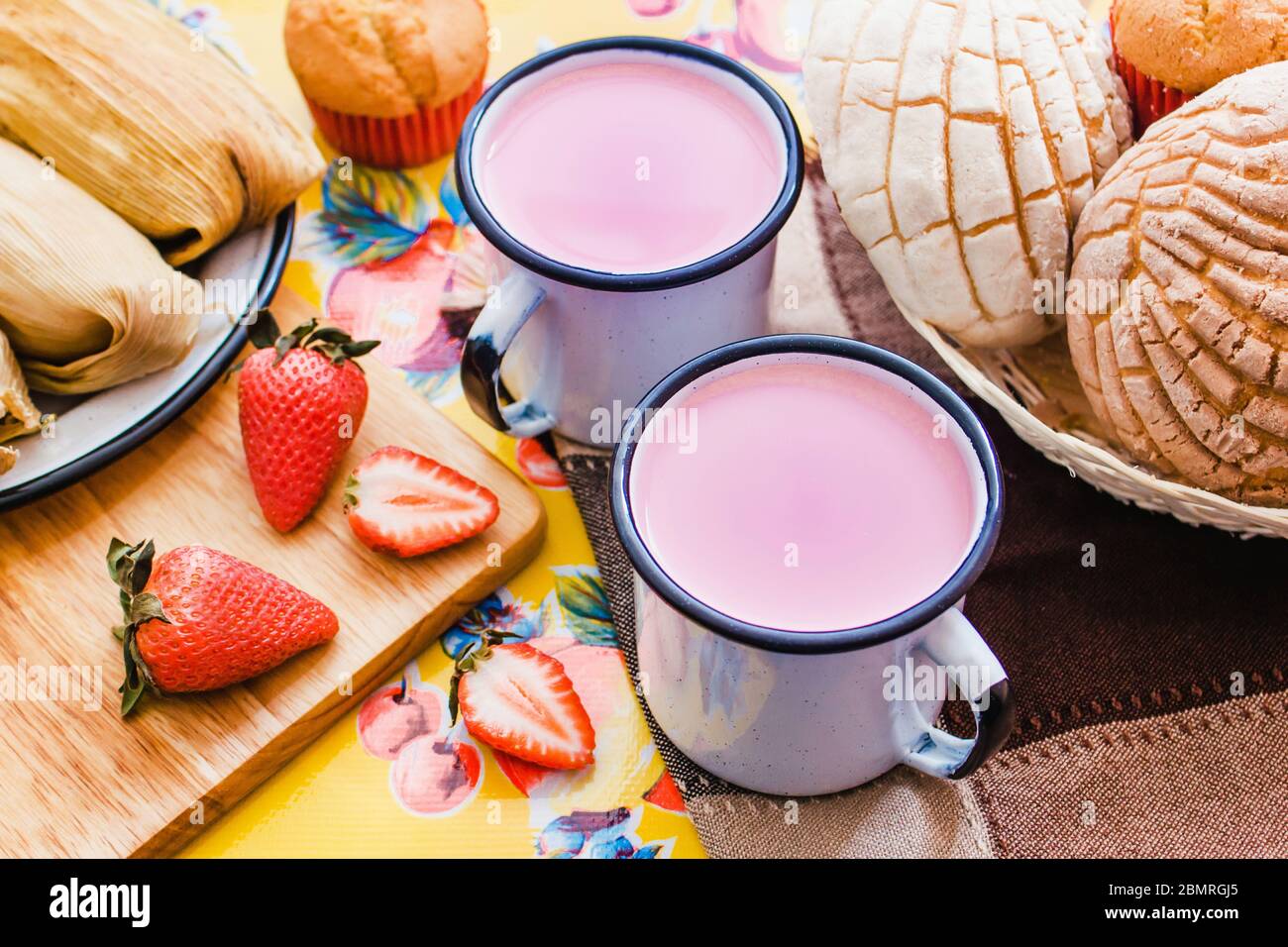 Atole de fresa, mexican traditional beverage and bread, Made with cinnamon and strawberries in Mexico Stock Photo