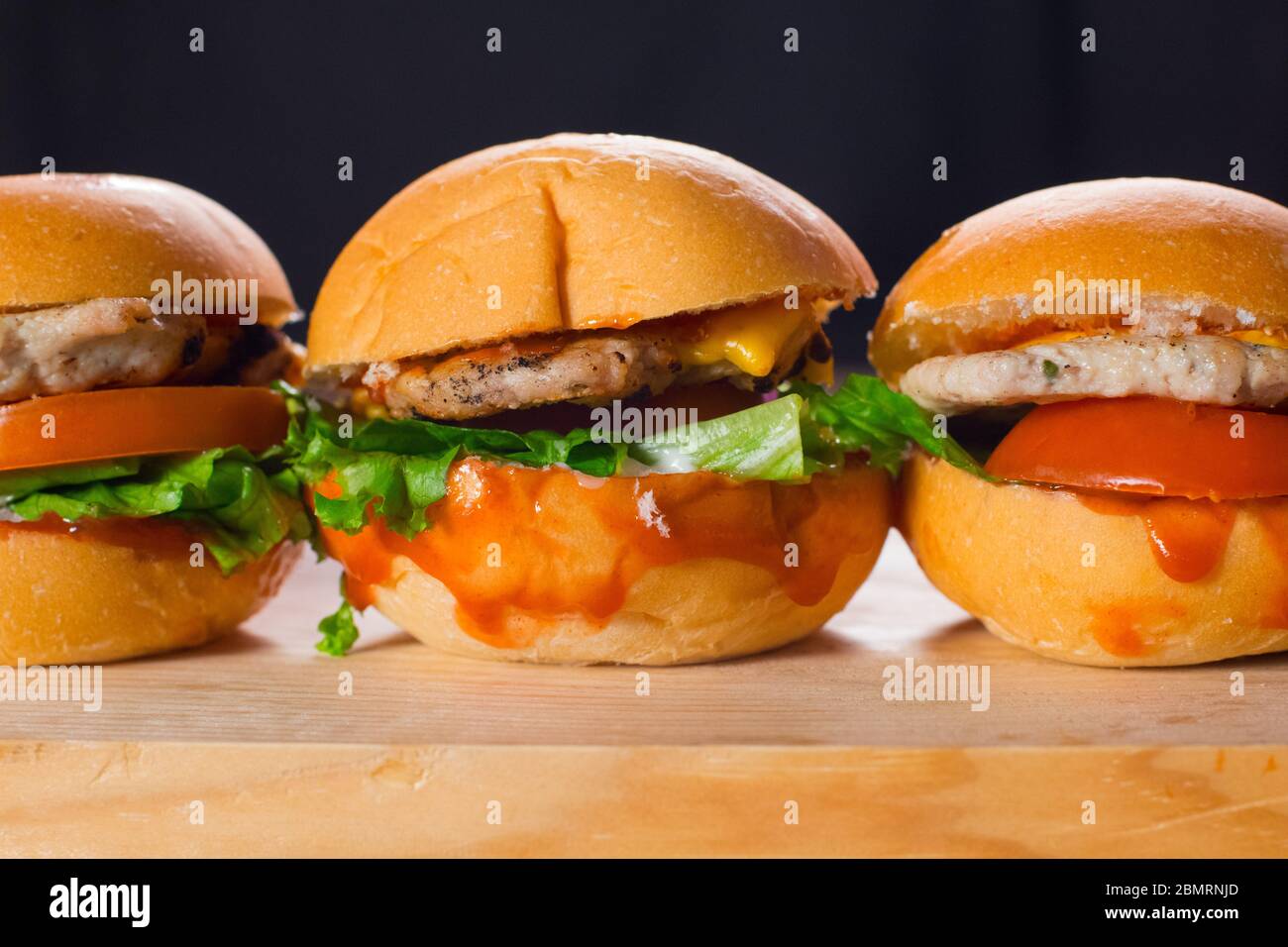 Juicy Spicy Chicken Burgers With Lettuce and Tomato. Tasty Chicken