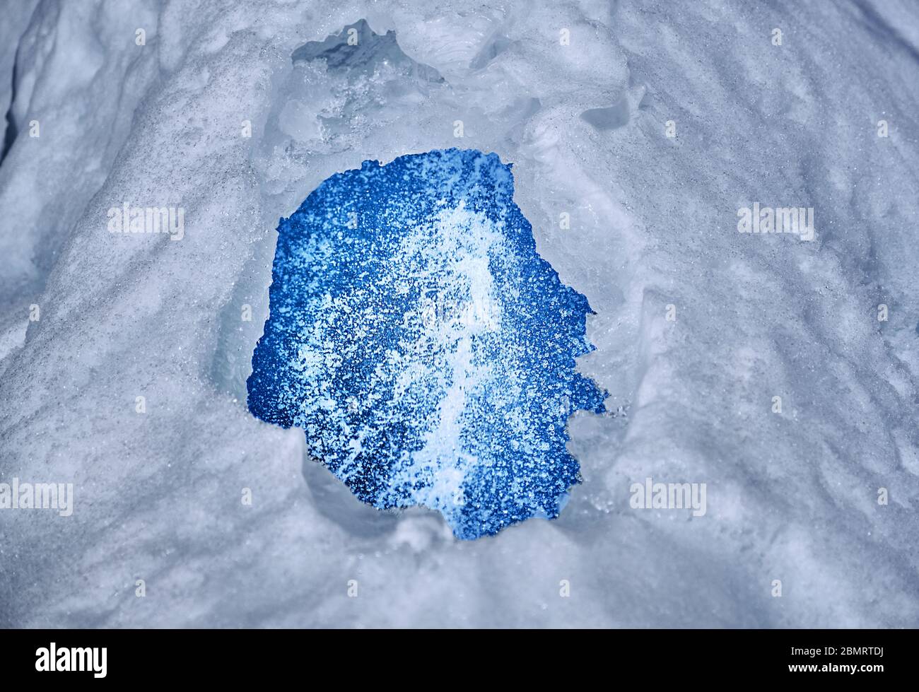 Spectacular jets of crystal clear water among the texture of ice; cleanness of water resources, snow melting and the arrival of spring Stock Photo