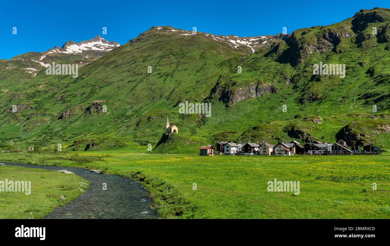 little ancient village in the mountains with church on the hill Stock Photo