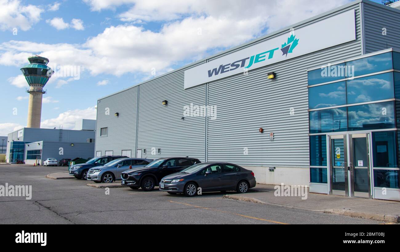 WestJet Airlines office at their base inside Toronto Pearson Intl. Airport, NavCanada ATC tower in the background. Stock Photo