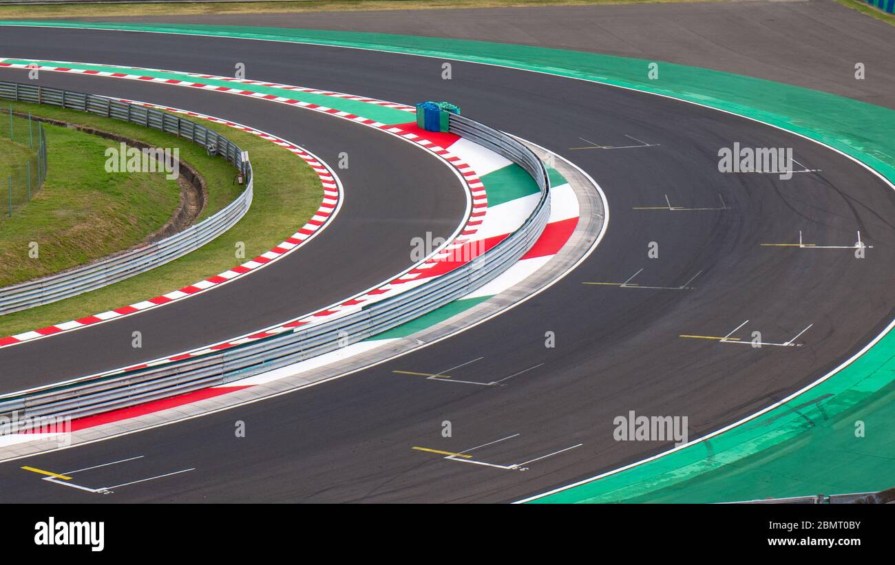 Motor racing circuit Red and White Kerb. A race track bend with grid signs and wheel arches. Stock Photo