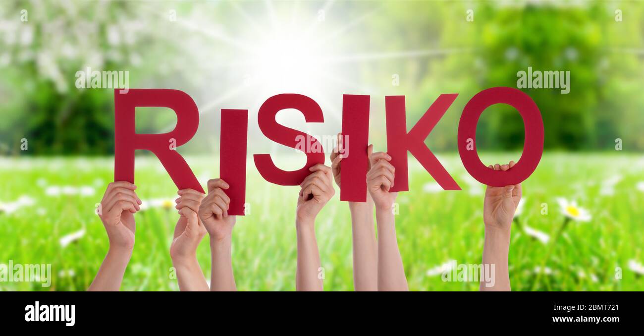 People Hands Holding Word Risiko Means Risk, Grass Meadow Stock Photo
