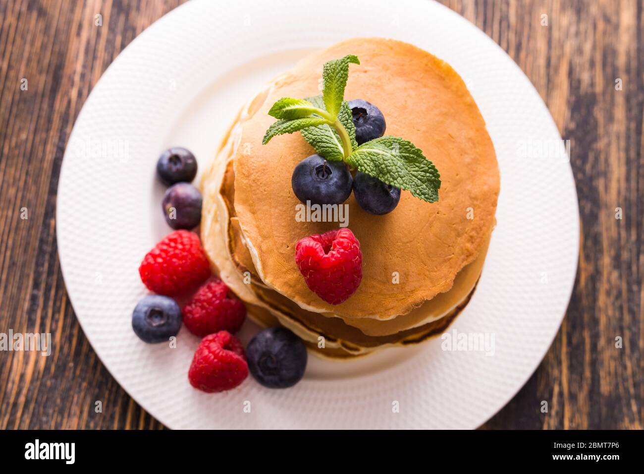 Pancakes Raspberry Blueberries Mint Homemade sweet pancakes with blueberries and raspberries on a white ...