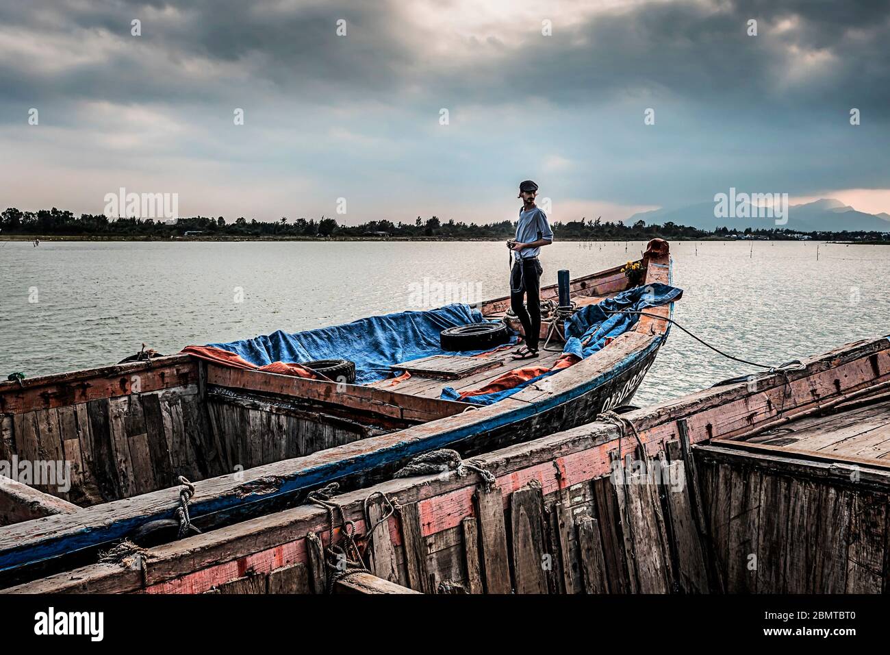 Man standing boat hi-res stock photography and images - Alamy