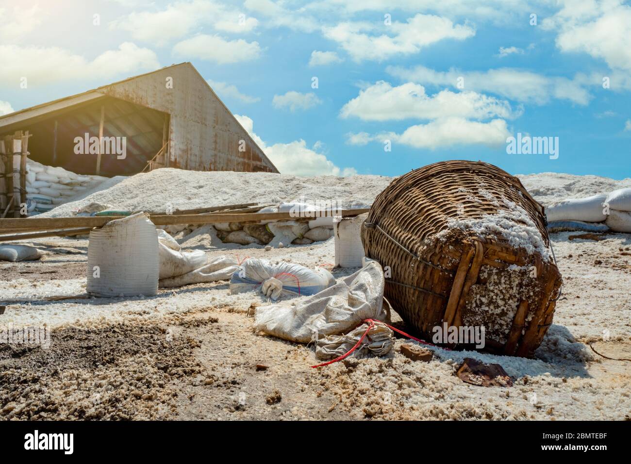 Barn with brine salt in sack. Pile of organic sea salt and bamboo