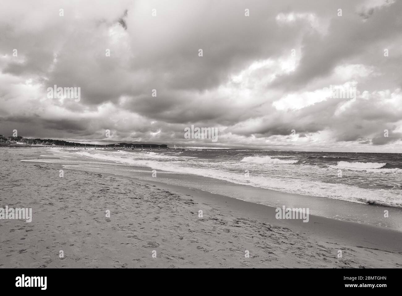 Lonely beach on a cloudy day in black and white Stock Photo - Alamy