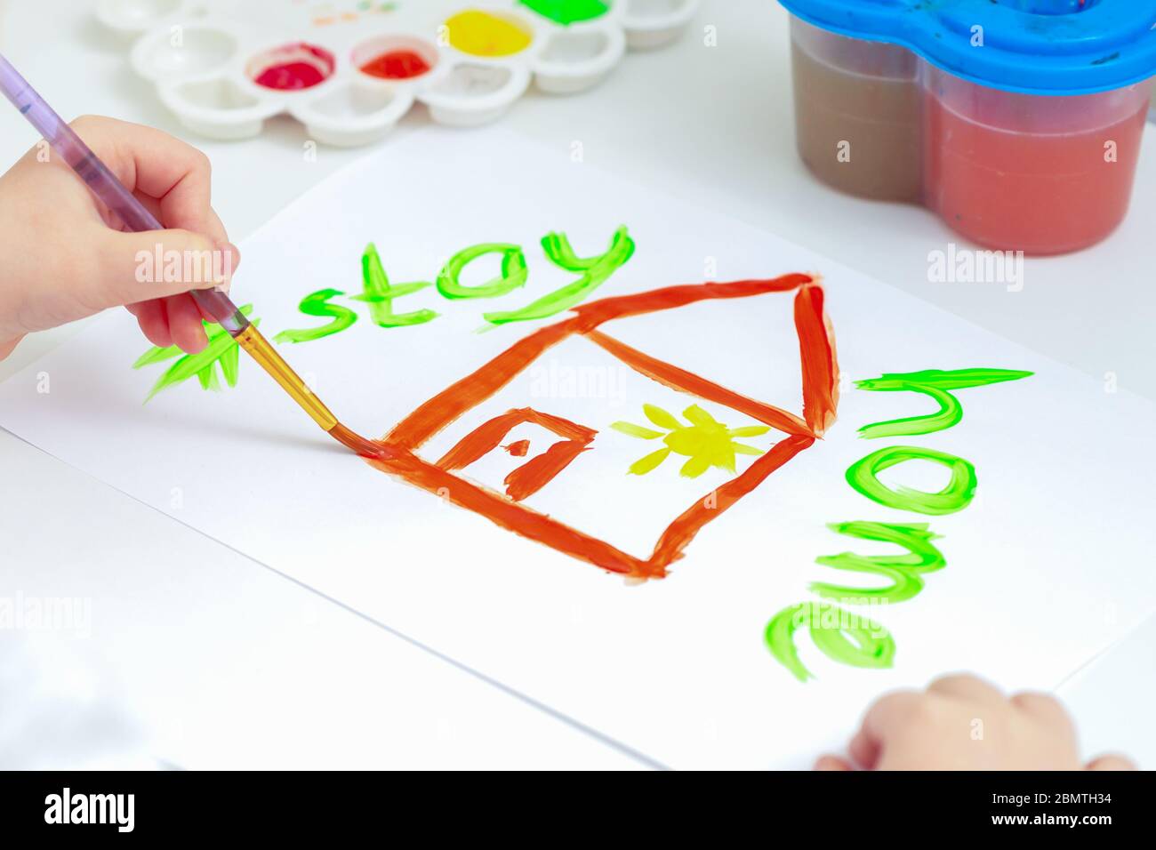 Close up of house painted on a white sheet of paper with the words Stay Home. Stock Photo