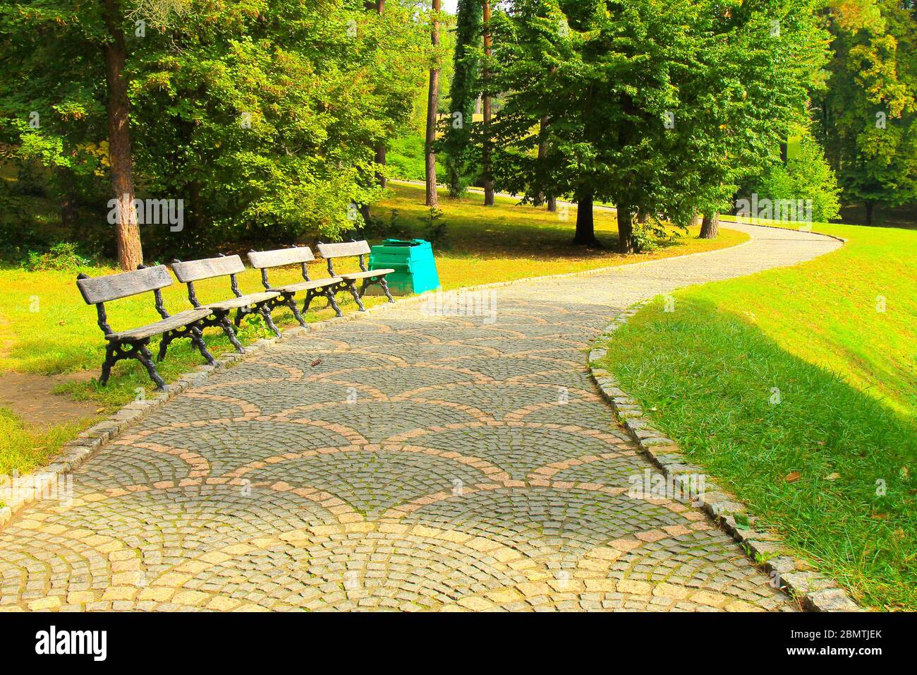 Park summer background. Stone walkway, wooden benches, picturesque ...