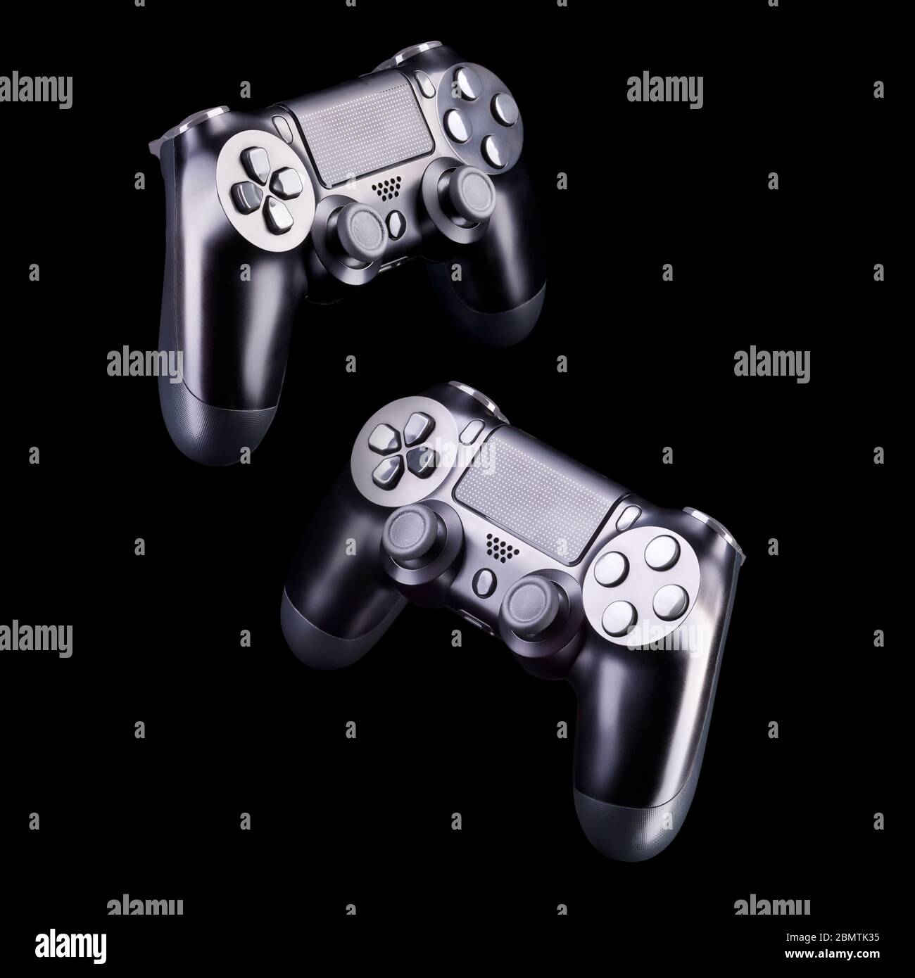Set of black video game joysticks gamepad isolated on a black ...