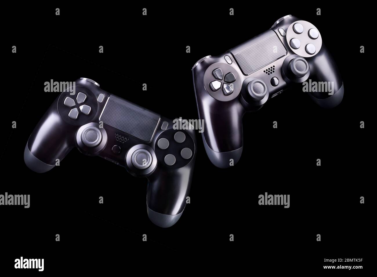 Set of black video game joysticks gamepad isolated on a black ...