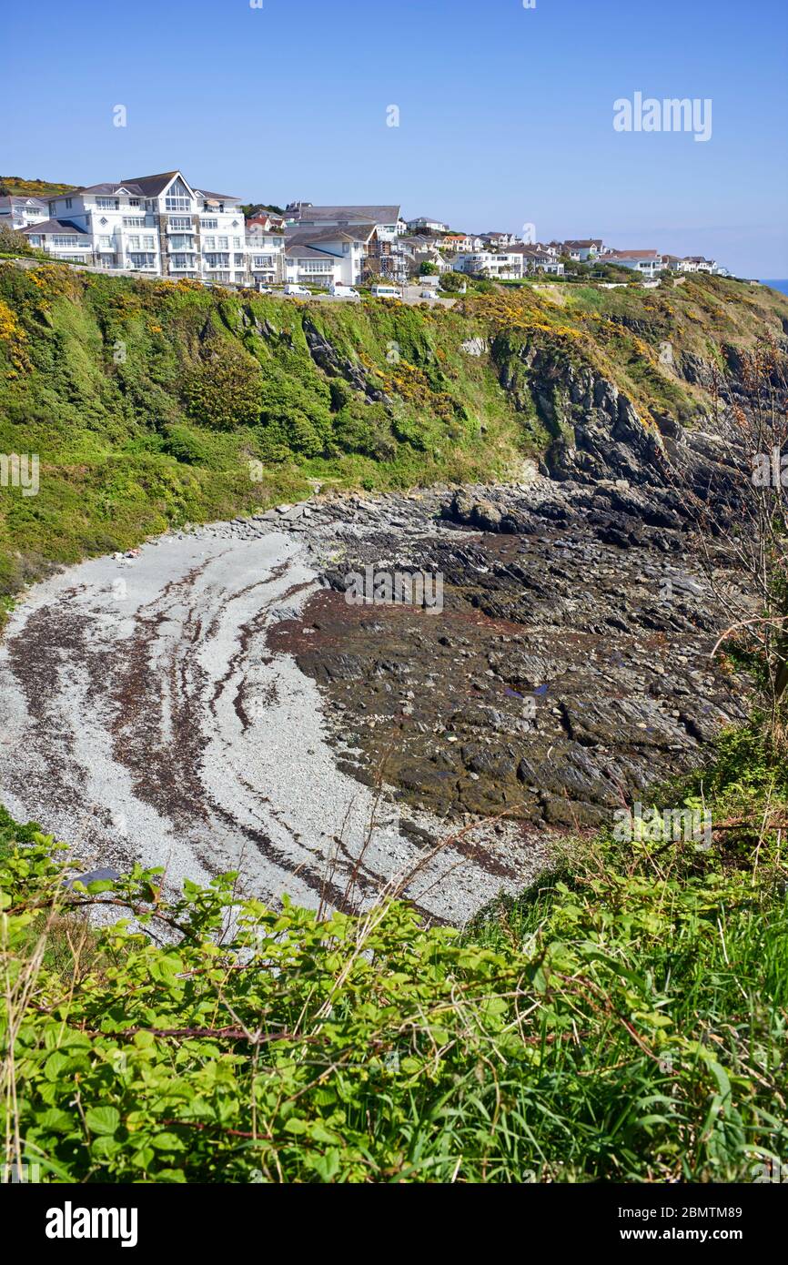 A couple sit on a deserted Onchan harbour bay at low tide during Coronavirus lockdown times Stock Photo