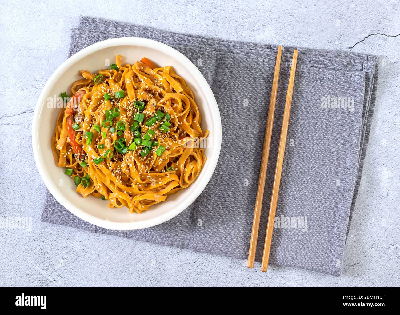 Top view of asian vegetarian chili noodles with bamboo chopsticks Stock Photo
