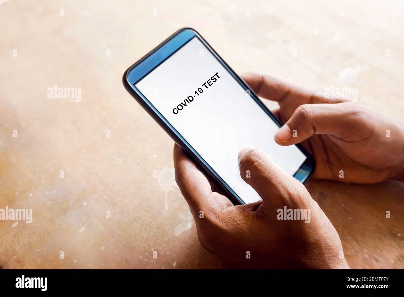 'Covid-19 test' text on smart phone Stock Photo