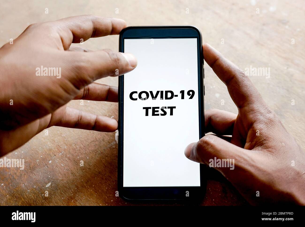 'Covid-19 test' text on smart phone Stock Photo
