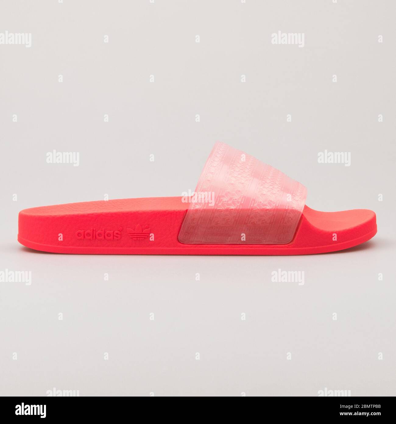 VIENNA, AUSTRIA - FEBRUARY 19, 2018: Adidas Adilette Lilo red and pink sandal on white background. Stock Photo