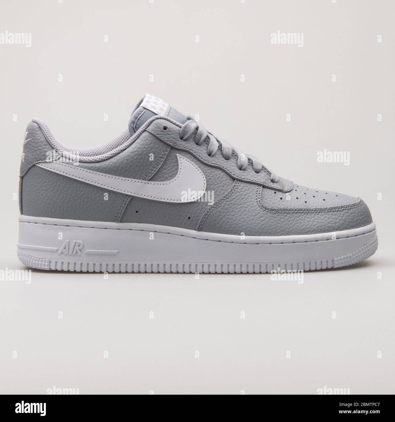 VIENNA, AUSTRIA - 2018: Nike Air Force 1 07 grey and white sneaker on background Stock Photo -