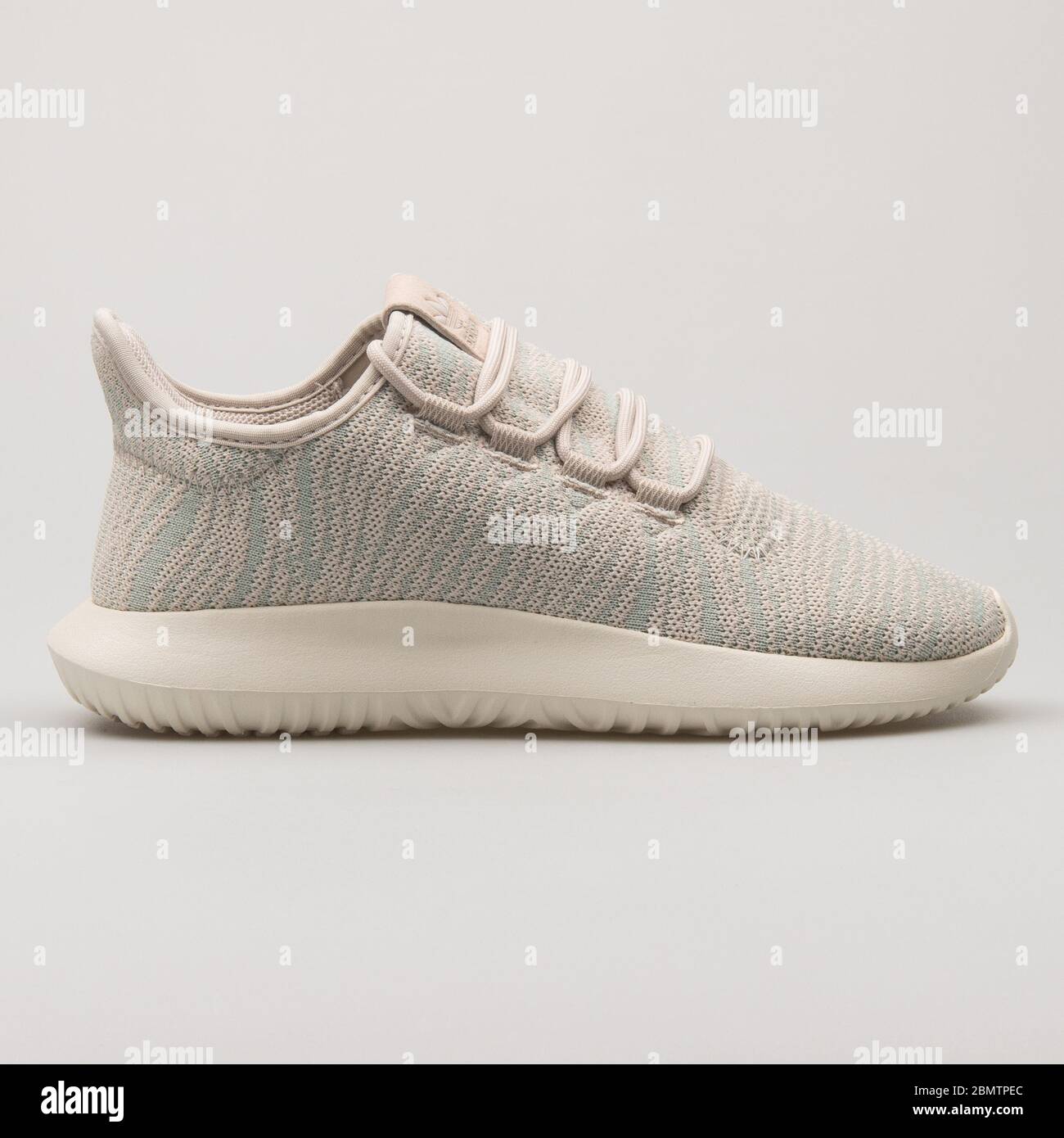 VIENNA, AUSTRIA - FEBRUARY 19, 2018: Adidas Tubular Shadow beige and green sneaker on white background. Stock Photo