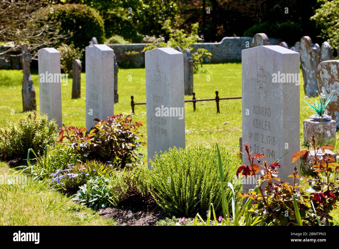 Deserted churchyard of The Priory church of Lady St Mary where the tomb stones of German servicemen killed in WW2 lie buried. VE Day May 2020 Wareham Stock Photo