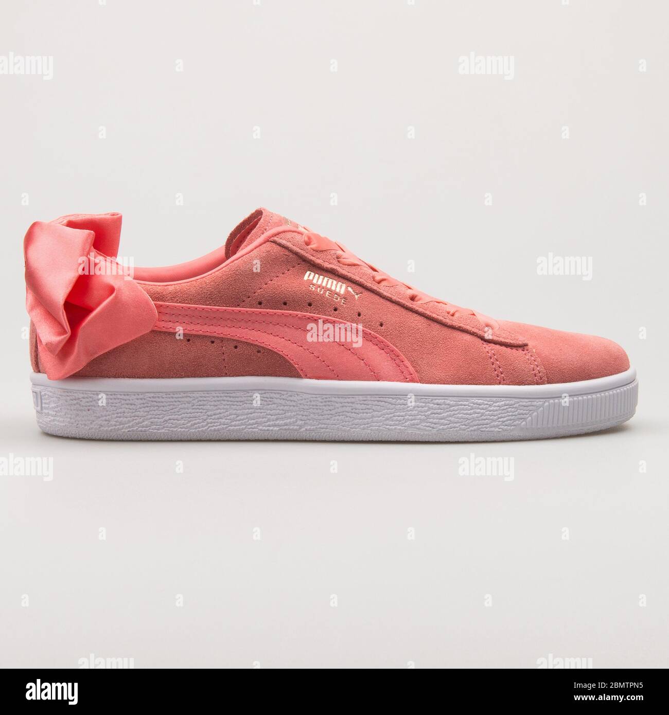 VIENNA, AUSTRIA - FEBRUARY 19, 2018: Puma Suede Bow AC pink sneaker on white background. Stock Photo