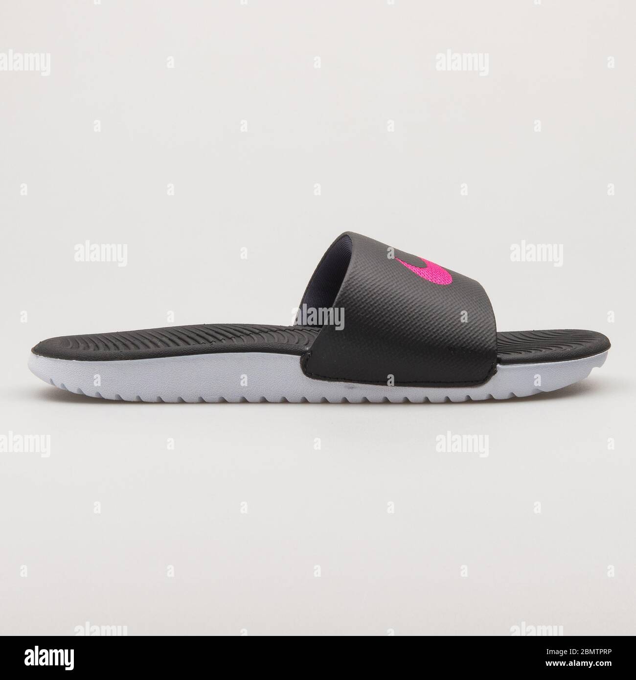 VIENNA, AUSTRIA - FEBRUARY 19, 2018: Nike Kawa Slide black, pink and white sandal on white background. Stock Photo