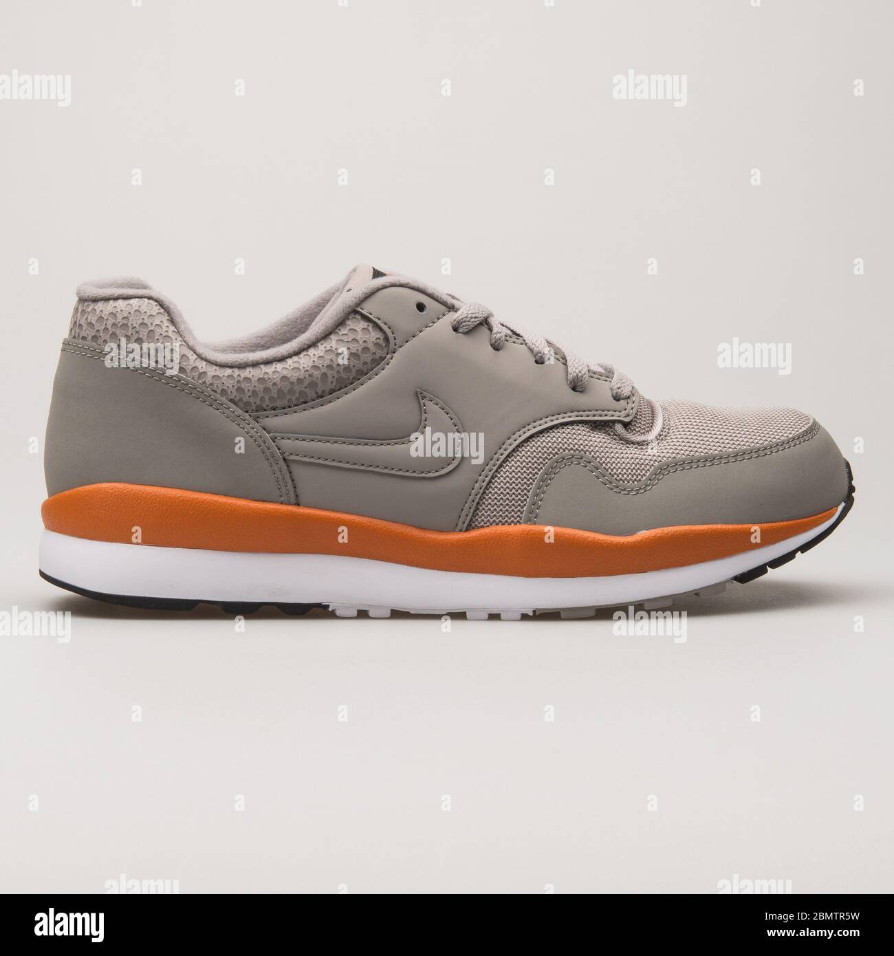 VIENNA, AUSTRIA - MAY 27, 2018: Nike Air Safari stone grey and orange sneaker on white background. Stock Photo