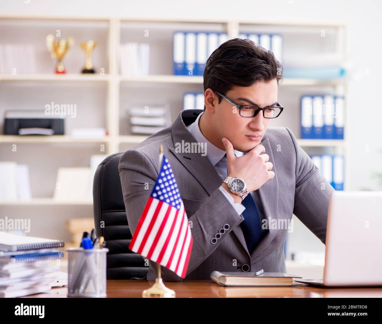 The businessman with american flag in office Stock Photo - Alamy
