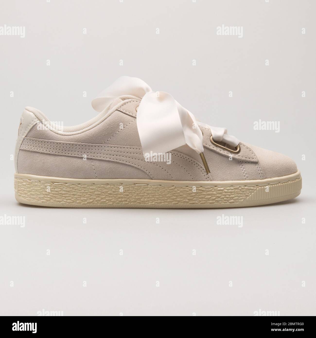 VIENNA, AUSTRIA - MAY 27, 2018: Puma Suede Heart Satin beige and gold  sneaker on white background Stock Photo - Alamy