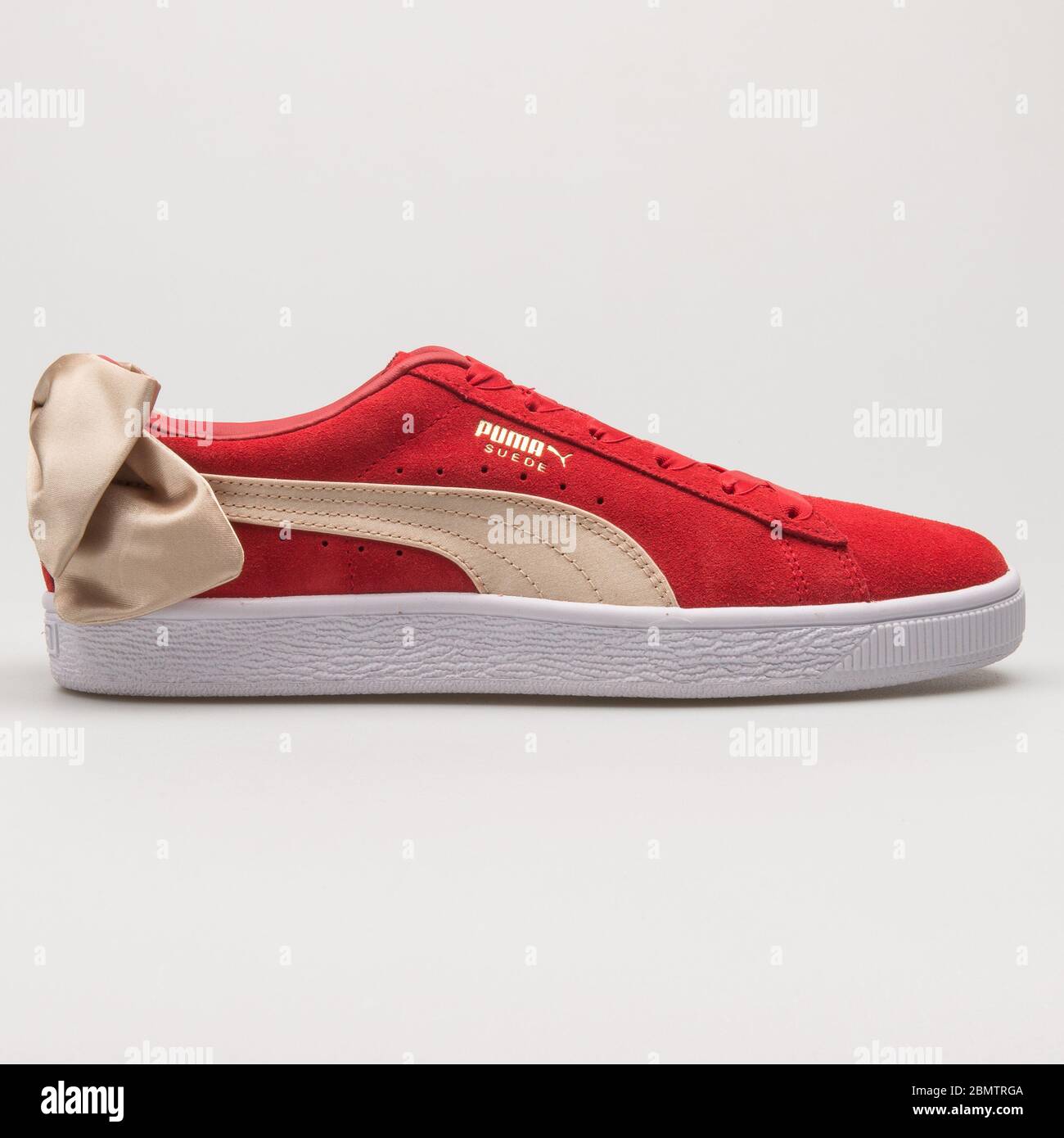 VIENNA, AUSTRIA - MAY 27, 2018: Puma Suede Bow Varsity red and gold sneaker  on white background Stock Photo - Alamy