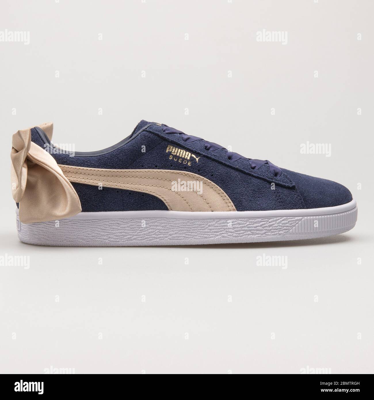 VIENNA, AUSTRIA - MAY 27, 2018: Puma Suede Bow Varsity navy blue and gold  sneaker on white background Stock Photo - Alamy