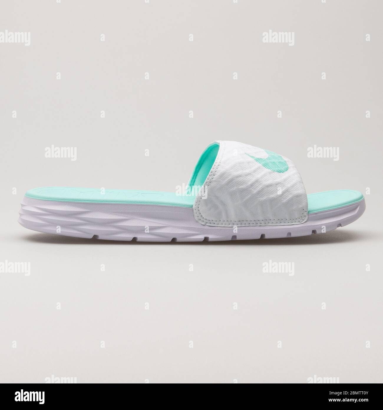 VIENNA, AUSTRIA - JUNE 14, 2018: Nike Benassi Solarsoft white and teal  sandal on white background Stock Photo - Alamy