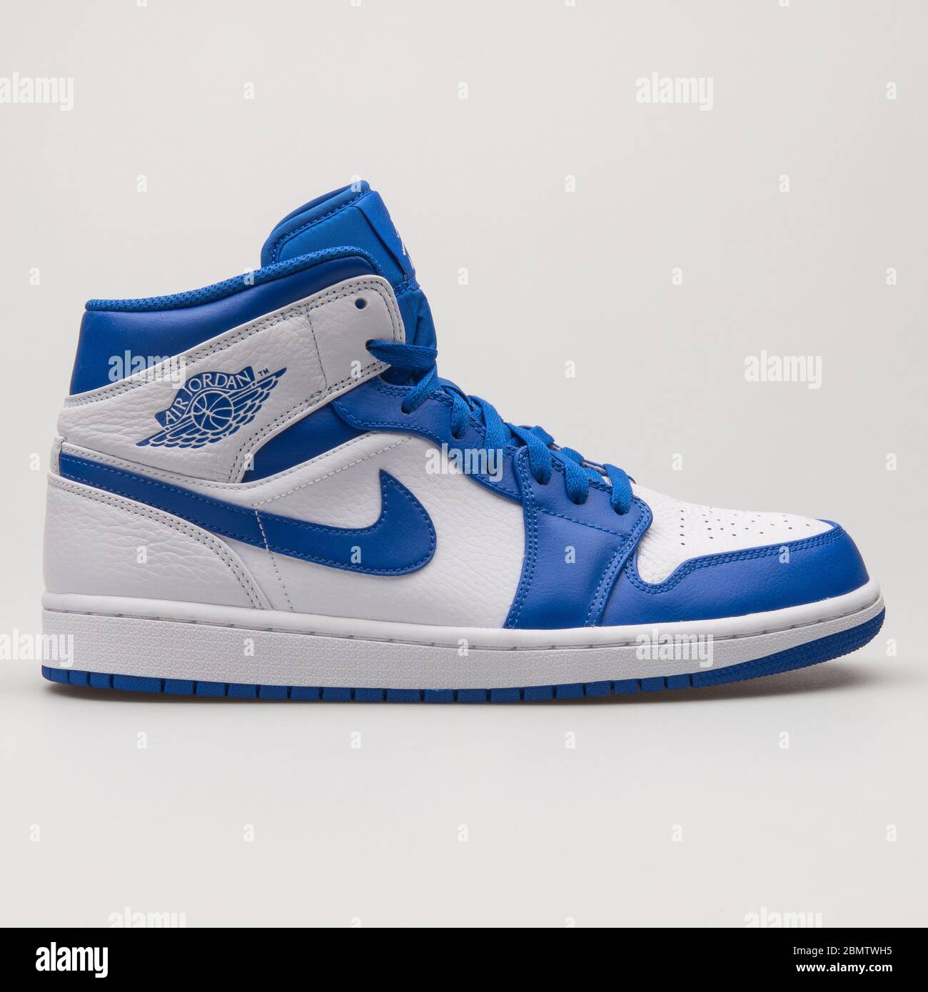 VIENNA, AUSTRIA - JUNE 14, 2018: Nike Air Jordan 1 Mid blue and white sneaker on white background. Stock Photo