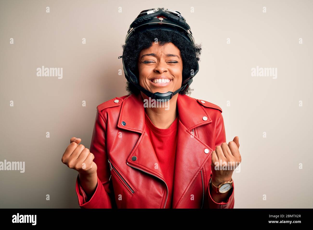 Young African American afro motorcyclist woman with curly hair wearing