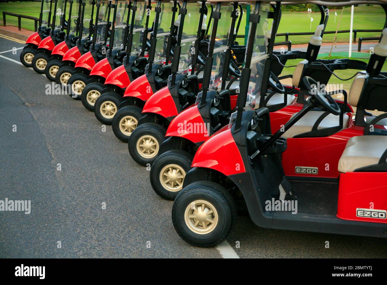 Golf Buggies (carts) in a line ready to go. Stock Photo