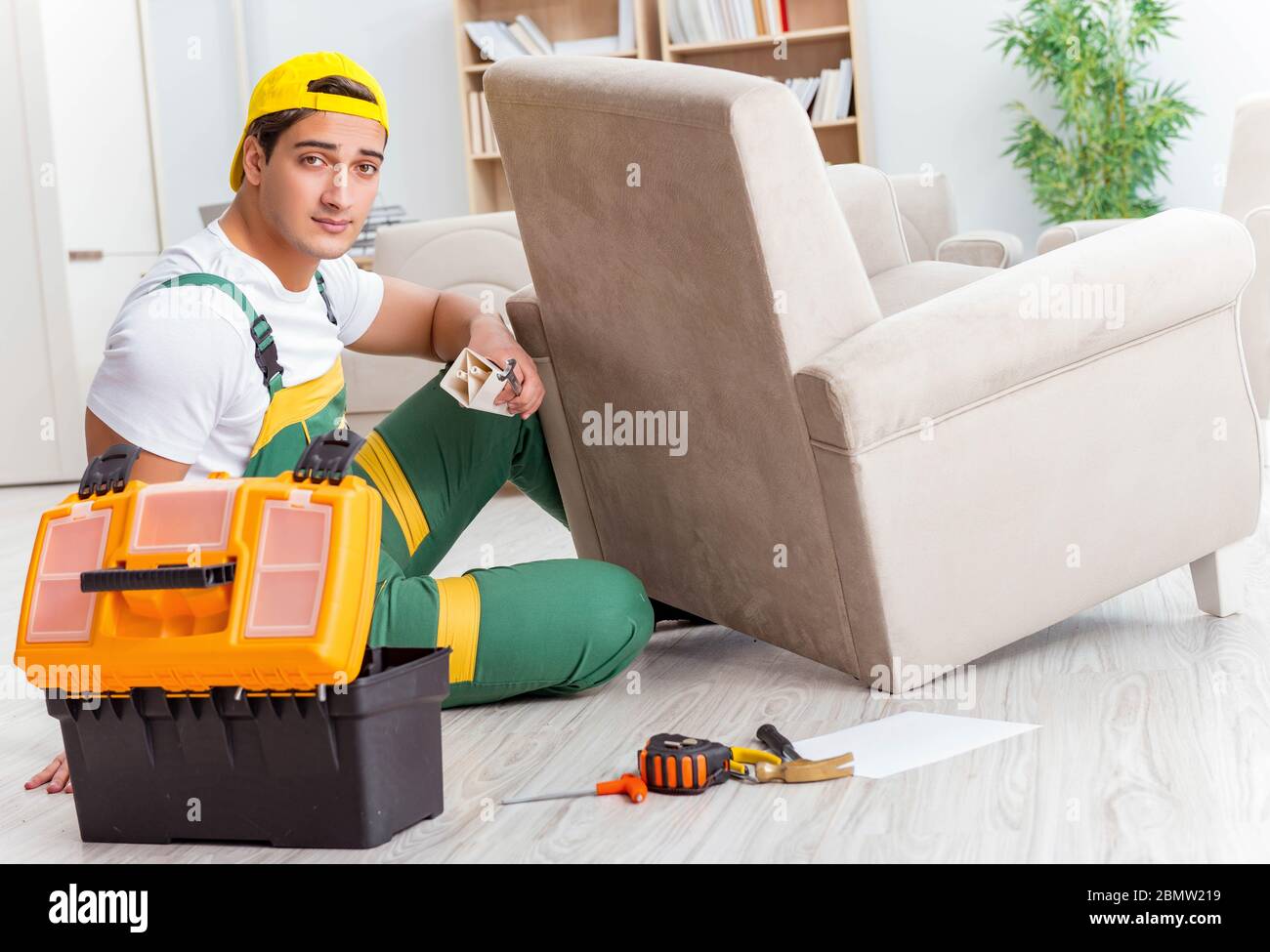 The worker repairing furniture at home Stock Photo - Alamy