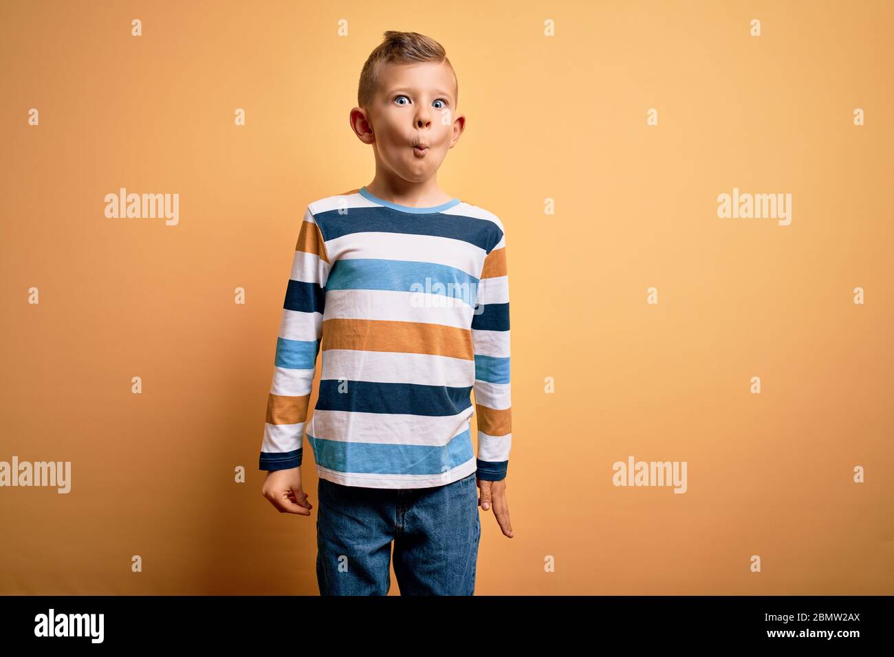 Teenager boy wearing yellow t-shirt over isolated background making fish  face with lips, crazy and comical gesture. Funny expression Stock Photo -  Alamy