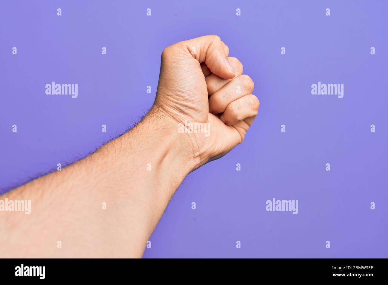 Hand Using Force Hand of caucasian young man showing fingers over isolated purple ...