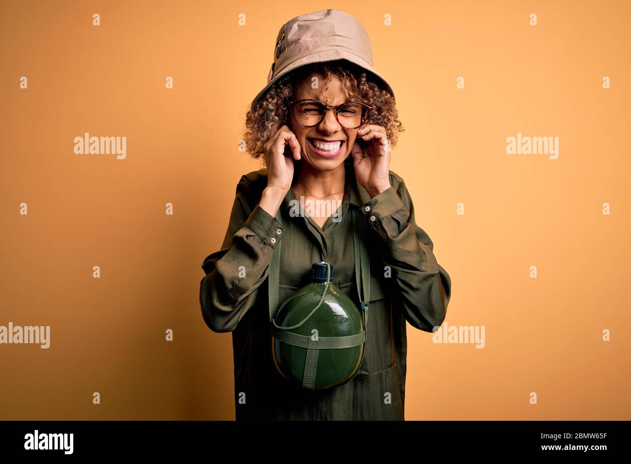 Young african american tourist woman on vacation wearing explorer hat ...