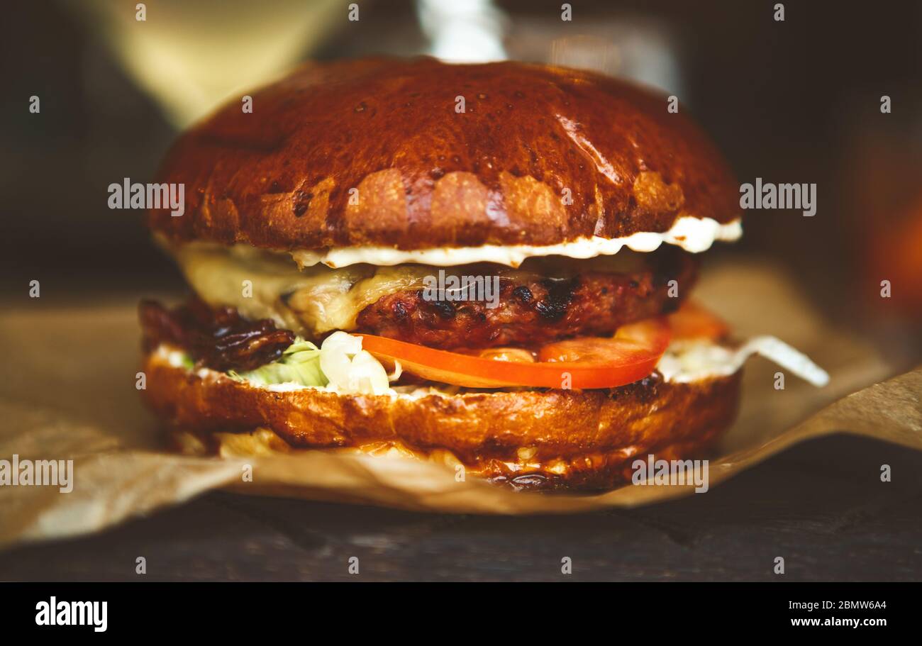 Fast food delivery.Delivered cheeseburger with beef meat,burned cheese