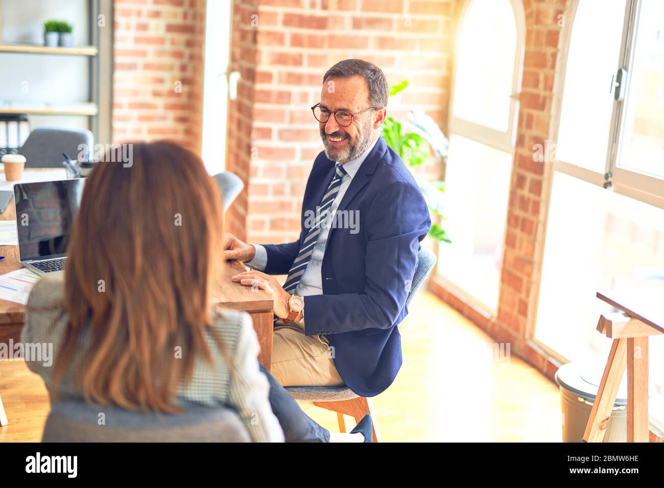 Two middle age business workers smiling happy and confident. Working ...