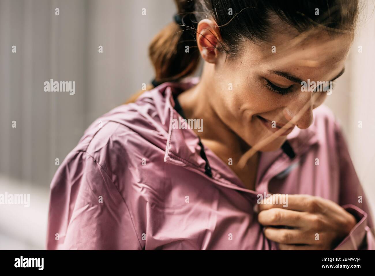 Woman wearing tracksuit and smiling. fitness woman looking happy before morning workout. Stock Photo