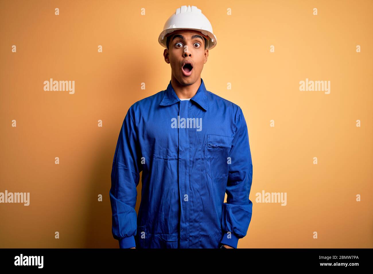 Young handsome african american worker man wearing blue uniform and ...
