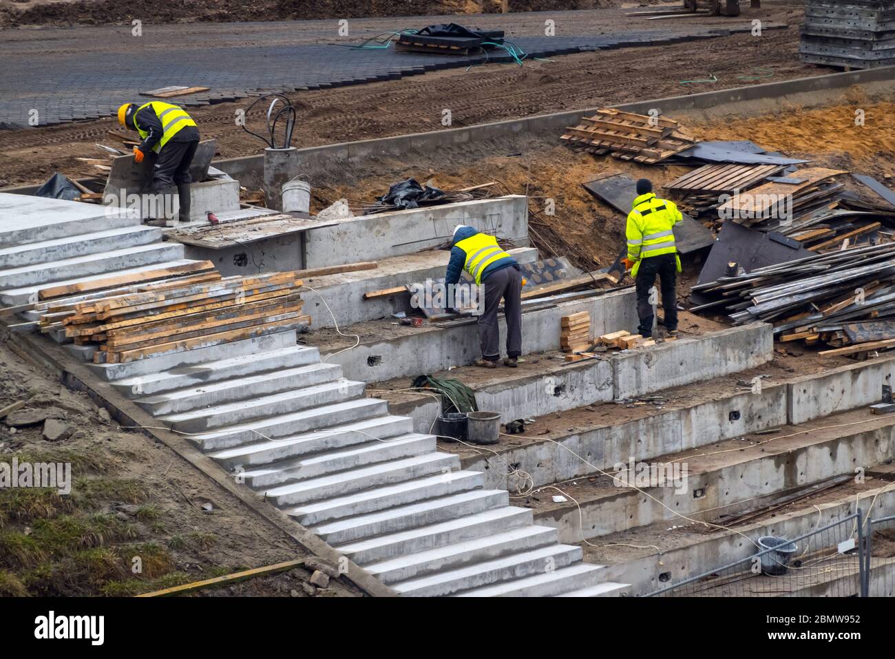 Builders working on construction foundation. Man strengthen concrete